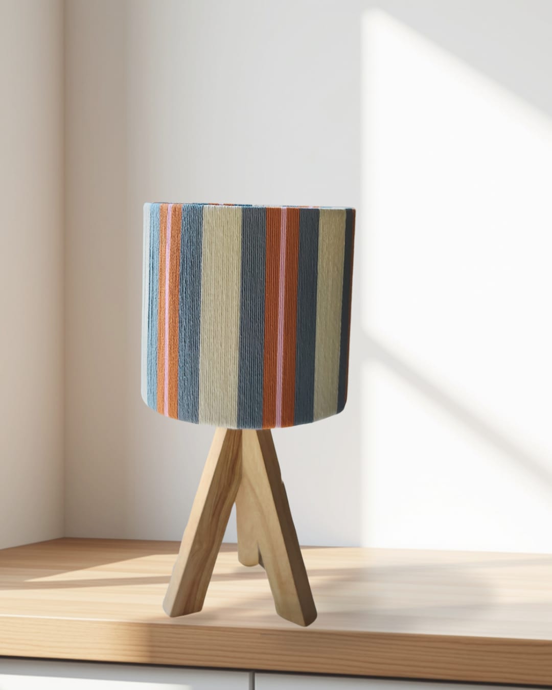 A blue and rust striped lamp in morning sun
