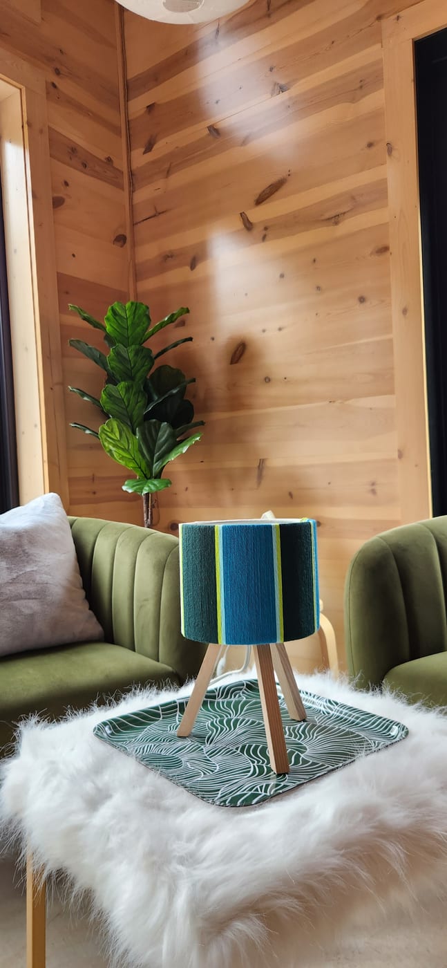A teal and lime lamp on a cabin side table