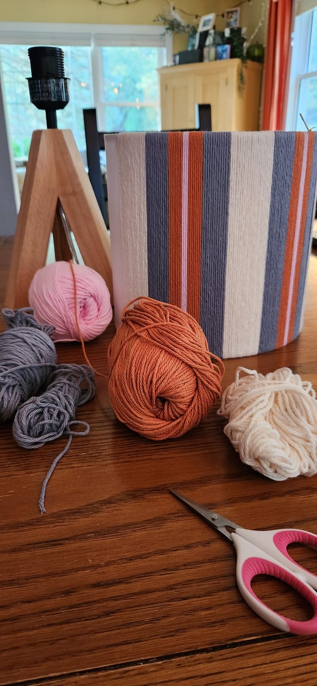 A half-wrapped shade among balls of yarn on a kitchen table