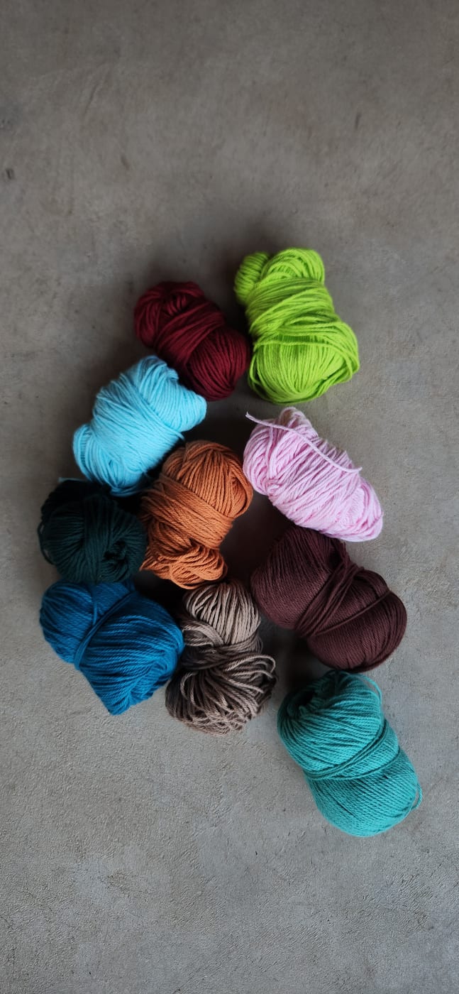 Balls of yarn in a dozen bright colours
